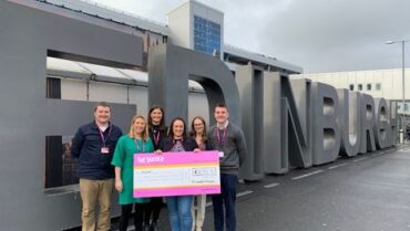 Team posing with donation cheque for The Larder charity
