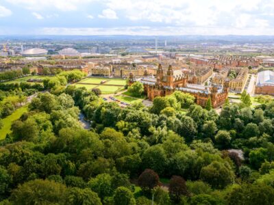 Image of Kelvingrove museum from above surrounded by trees.